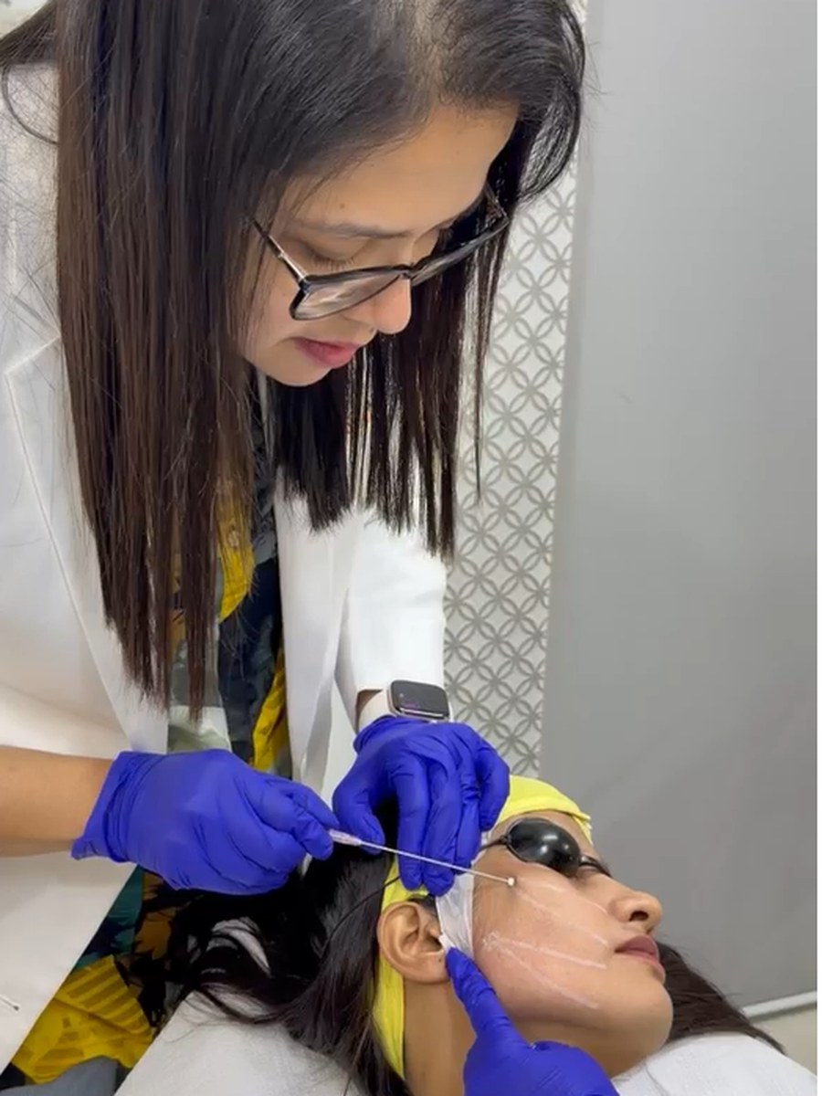 Dr. Sifat-E-Aman carrying out a facial treatment on a patient at her chamber.