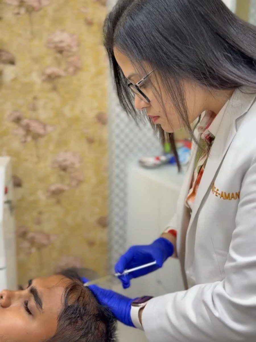 Dr. Sifat-E-Aman treating a patient's hairline at her chamber.