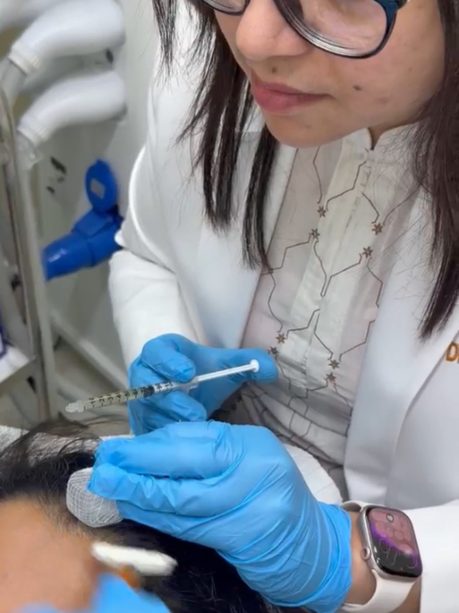 Dr. Sifat-E-Aman preparing an injectable treatment, gloved, at her chamber.