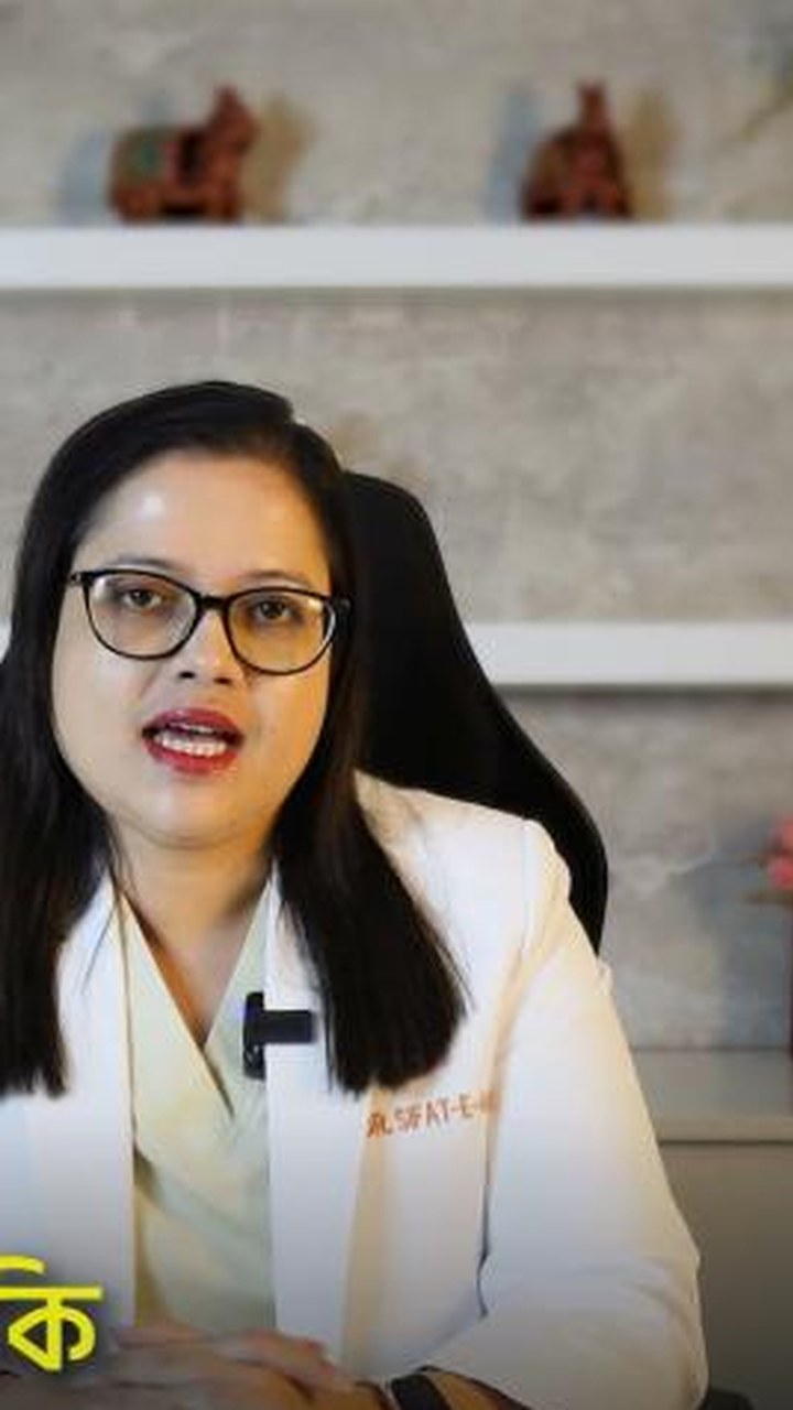 Dr. Sifat-E-Aman seated at her desk in a white coat, speaking to camera.